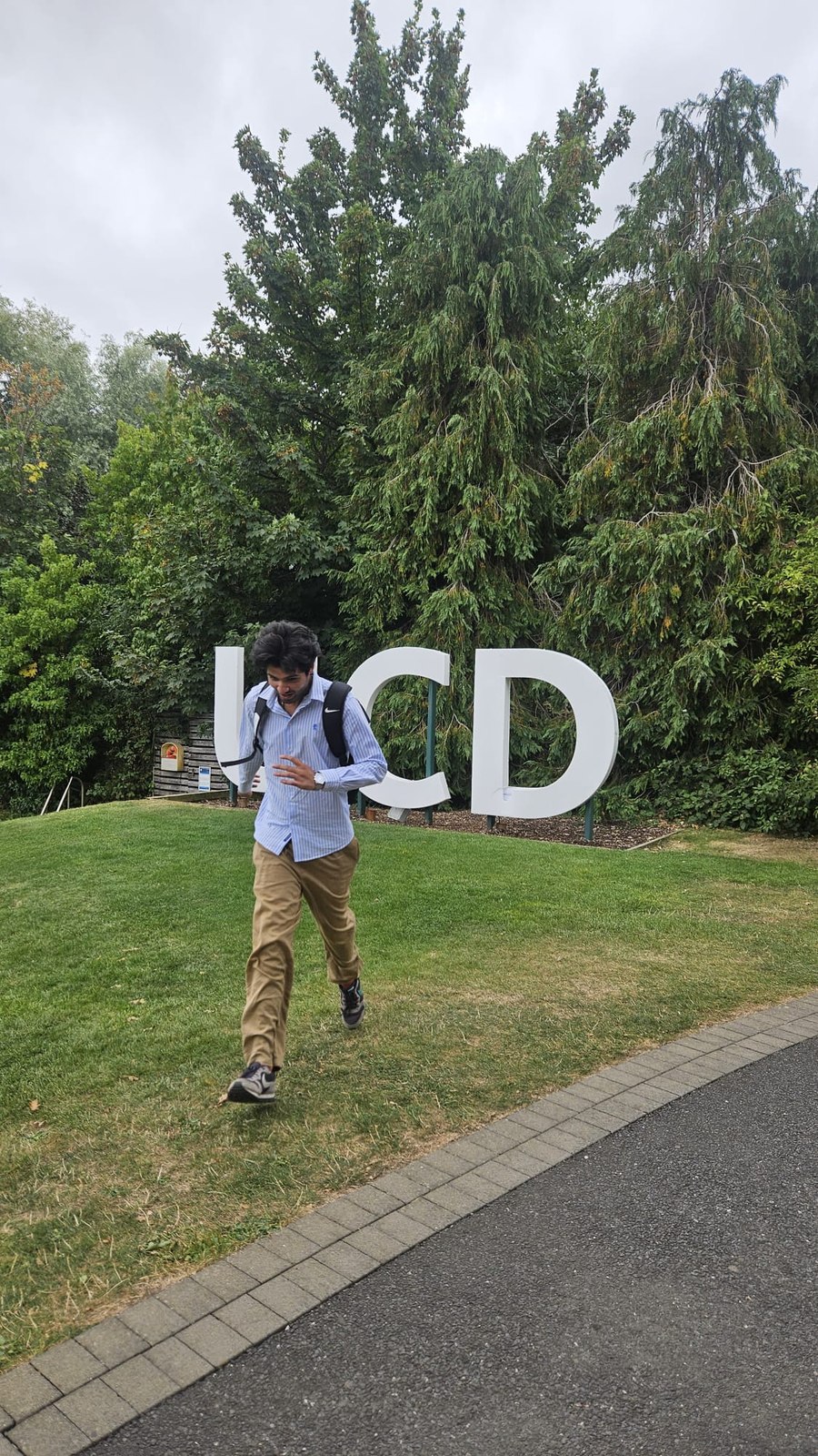Running past the UCD sign on campus